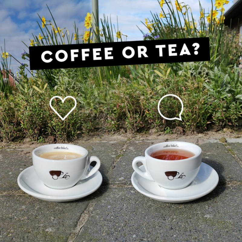 Two white Coffee-Bike cups with coffee and tea stand on a stone floor, above a heart and a comment icon, above a black bar with the words coffee or tea in white letters
