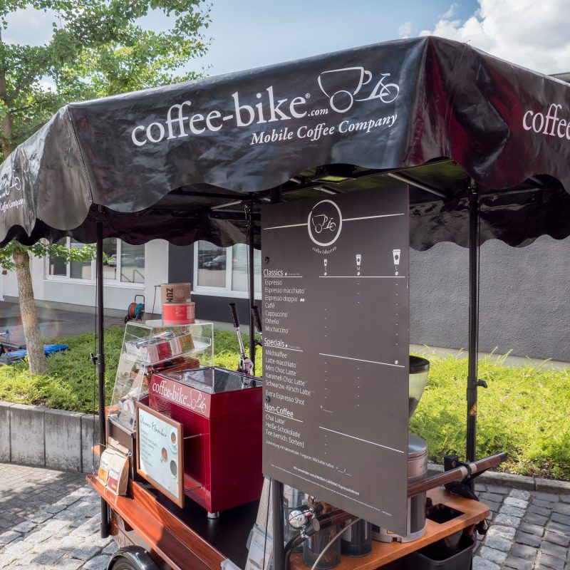 A crop of a fully equipped coffee bike with focus on the beverage table