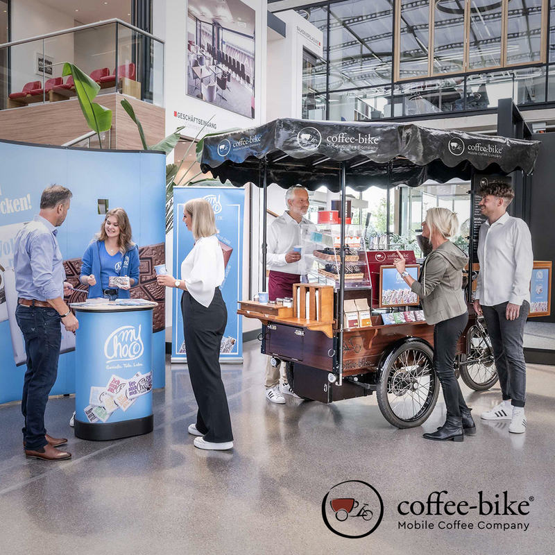 The Coffee-Bike stands on an exhibition stand where people talk to each other