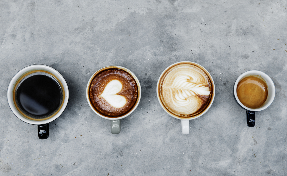 Four cups of coffee in different varieties, highlighting decaffeinated coffee.