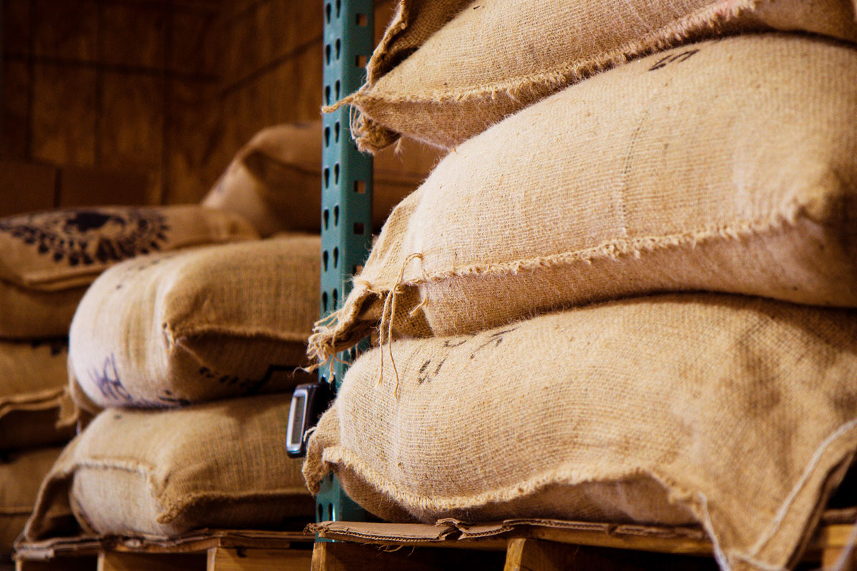Stacked coffee jute bags in a warehouse
