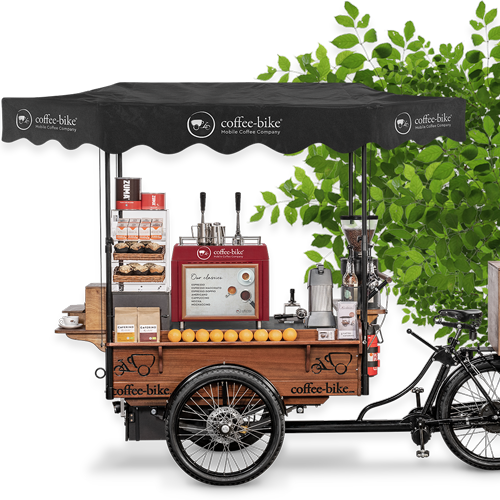 Mobile coffee bar with extended roof in front of a partially visible green plant